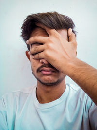 Portrait of young man against white background