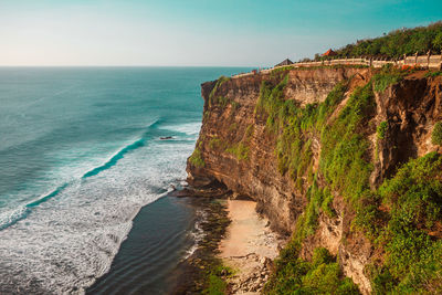 Sunset on the ocean coast, uluwatu beach, bali, indonesia. waves and cliffs in uluwatu