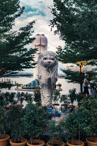 Statue in park against sky