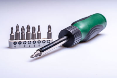 Interchangeable screwdriver set with different types of metal steel heads and bits, selective focus