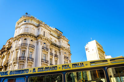 Low angle view of buildings against clear blue sky