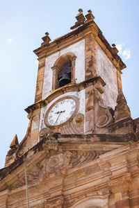 Low angle view of clock tower against sky