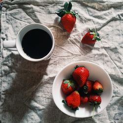 High angle view of strawberries and coffee on table