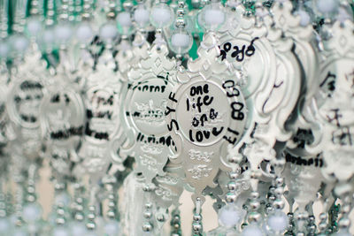 Close-up of decorations hanging in store for sale