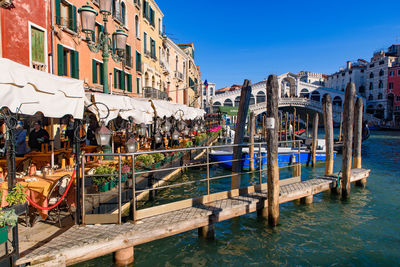 Boats in canal against buildings in city