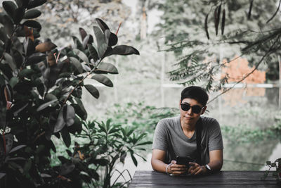 Portrait of man sitting on table