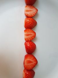 High angle view of strawberries on table against white background