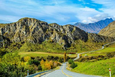 Empty road leading towards mountains