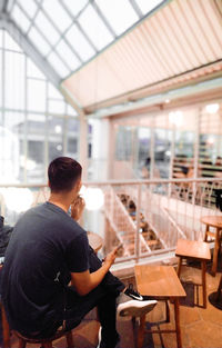 An asian man sits contemplating in a cafe, bogor, indonesia