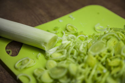 High angle view of chopped leek on cutting board