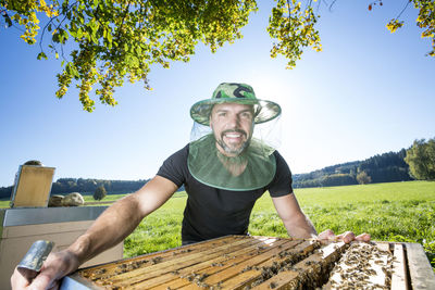 Portrait of man on field against sky