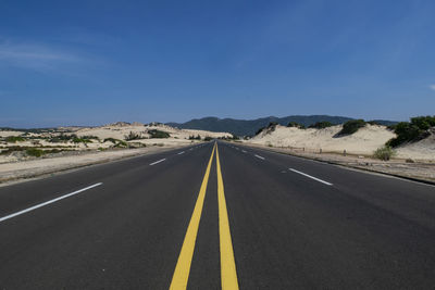 View of country road against blue sky