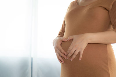 Midsection of woman touching hair