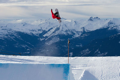 Snowboarder hits park jump at whistler