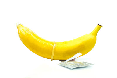 Close-up of yellow fruit against white background