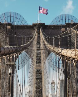 Low angle view of suspension bridge against sky