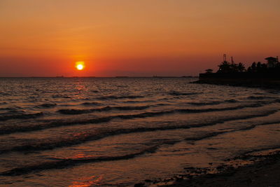 Scenic view of sea against orange sky