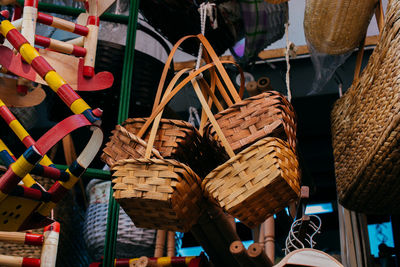 Close-up of clothes hanging in basket for sale at market stall