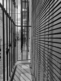 Footpath amidst buildings seen through window