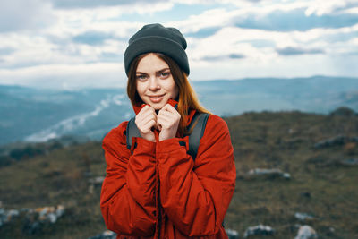 Portrait of young woman standing in snow