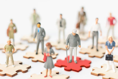 Close-up of toys on table against white background