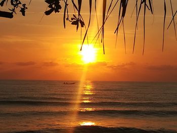 Scenic view of sea against orange sky