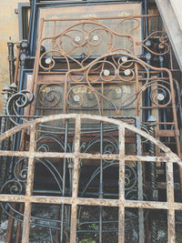 Low angle view of closed metal gate of old building