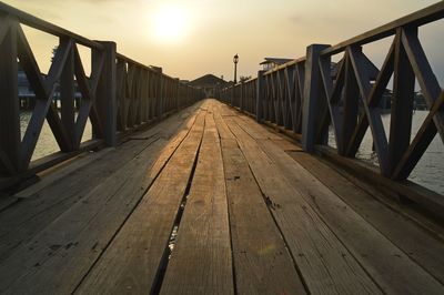 View of footbridge against sky during sunset