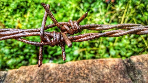 Close-up of rusty chain on field