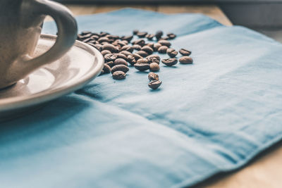 Close-up of roasted coffee beans on place mat