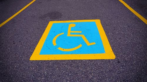 Close-up of yellow arrow symbol on road