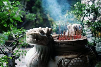 Burning incenses sticks in sculpture at temple