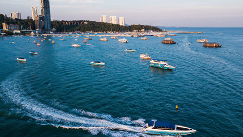 High angle view of sea and cityscape against sky