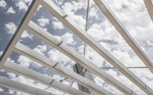 Low angle view of metallic structure on bridge against sky