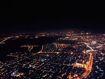 Aerial view of illuminated cityscape at night