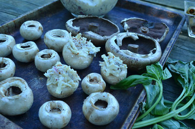 Preparing stuffed white mushroom appetizers for grilling outdoors