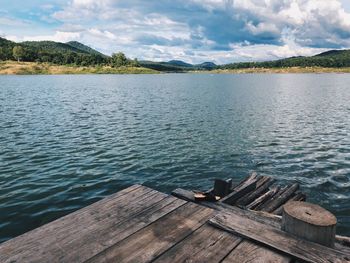 Pier on lake against sky