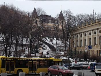 Cars on street amidst buildings in city