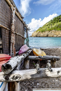 Boat moored on beach against sky