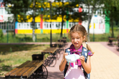 Portrait of smiling girl holding outdoors