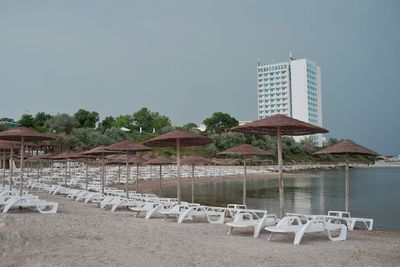 Gazebo on beach against buildings in city