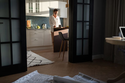 Female architect working in kitchen