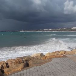 Scenic view of sea against cloudy sky