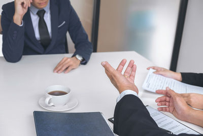 Businessmen discussing at desk in office