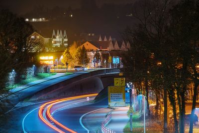 Illuminated swimming pool in city at night