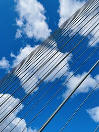 Low angle view of glass building against sky