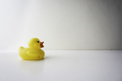 Close-up of yellow toy against white background