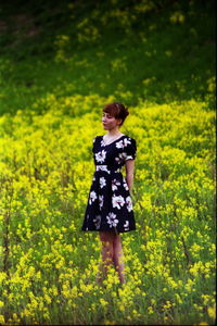 Young woman standing on grassy field