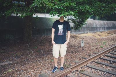 Man standing by railroad tracks