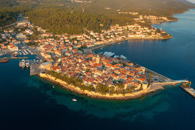 High angle view of sea and buildings in city